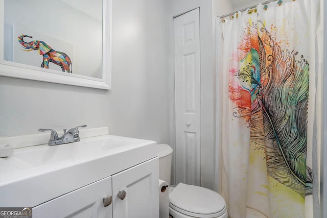 full bathroom with toilet and vanity