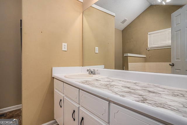 bathroom featuring lofted ceiling, baseboards, visible vents, and vanity