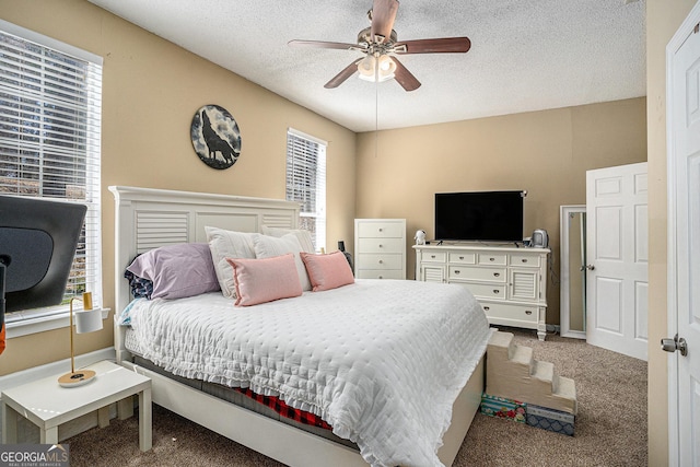 bedroom with carpet floors, ceiling fan, a textured ceiling, and baseboards