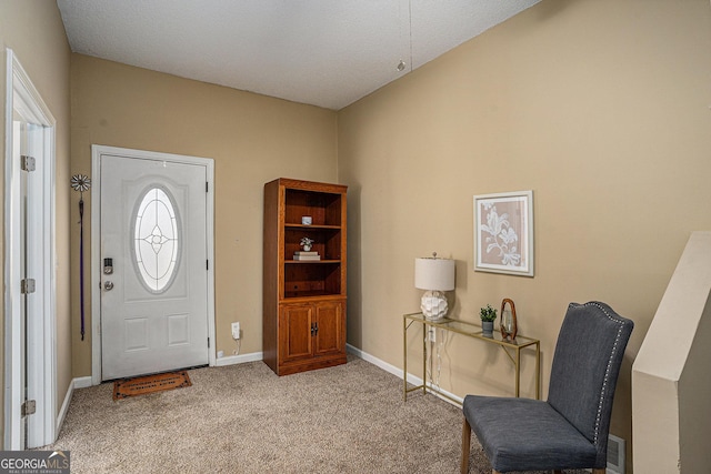 foyer with carpet and baseboards