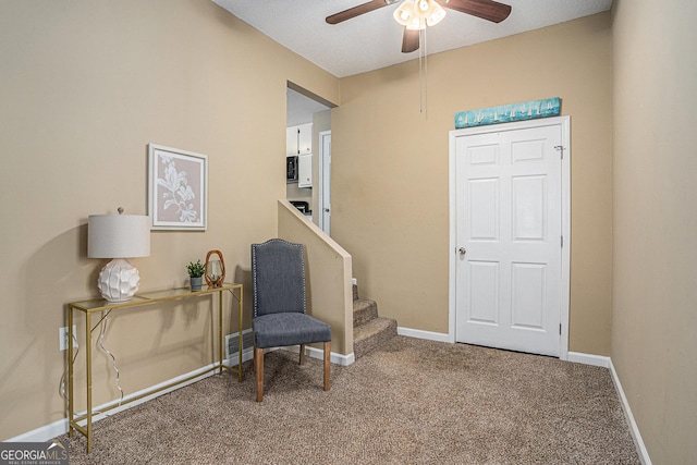 sitting room with a ceiling fan, carpet flooring, stairway, and baseboards