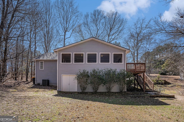 view of home's exterior featuring stairway, central AC unit, a deck, and a lawn