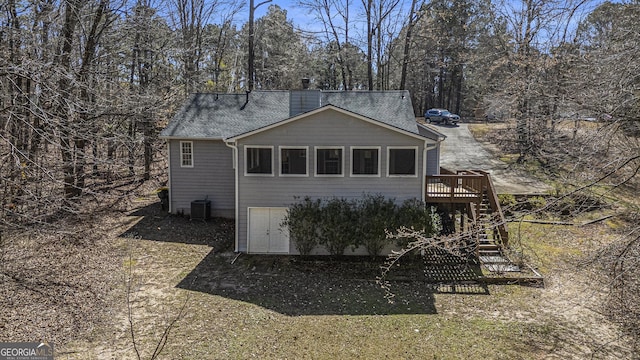 exterior space featuring a deck, stairway, and a chimney