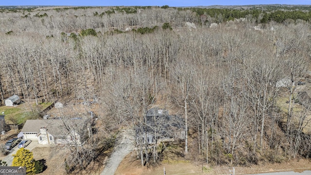 drone / aerial view featuring a view of trees