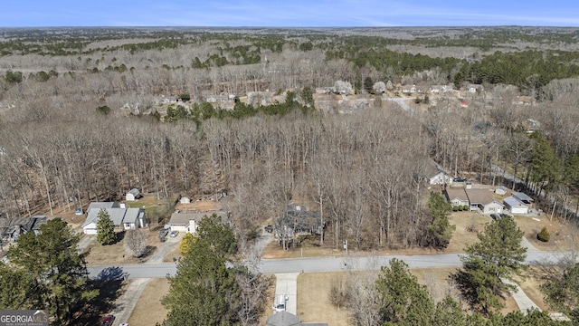 birds eye view of property with a wooded view