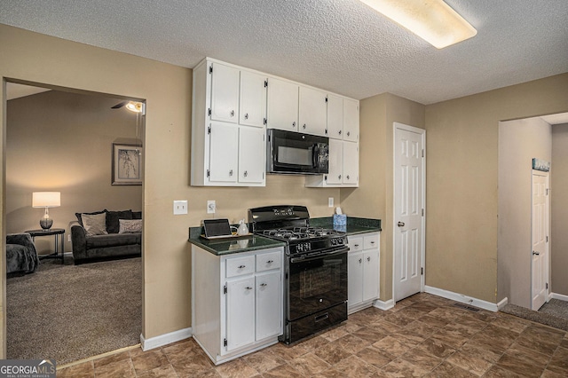 kitchen featuring dark countertops, baseboards, white cabinets, and black appliances