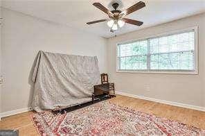 bedroom with baseboards and wood finished floors