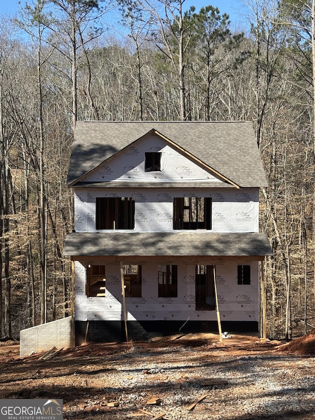 unfinished property with a wooded view