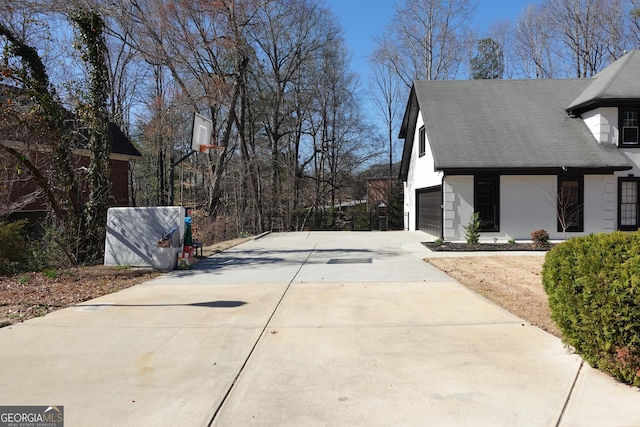 view of home's exterior featuring concrete driveway