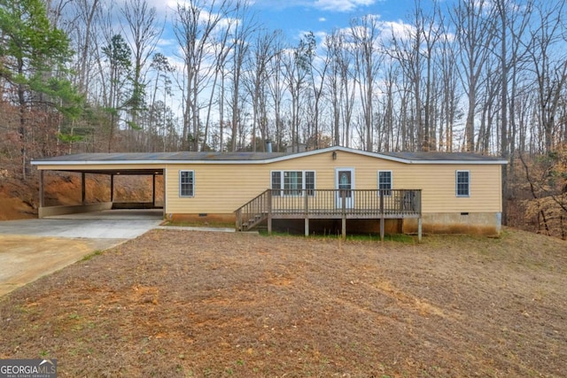 manufactured / mobile home featuring concrete driveway, crawl space, and a wooden deck