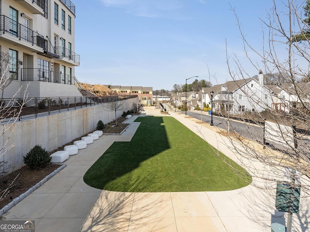 view of yard with a residential view and fence