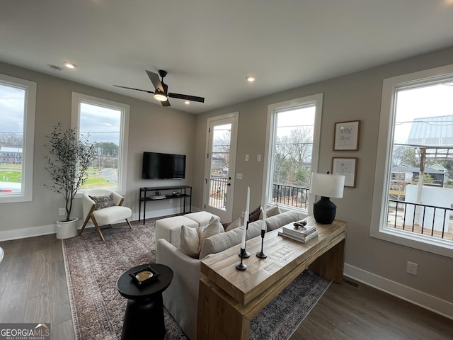 living room featuring dark wood-style floors, recessed lighting, visible vents, and baseboards