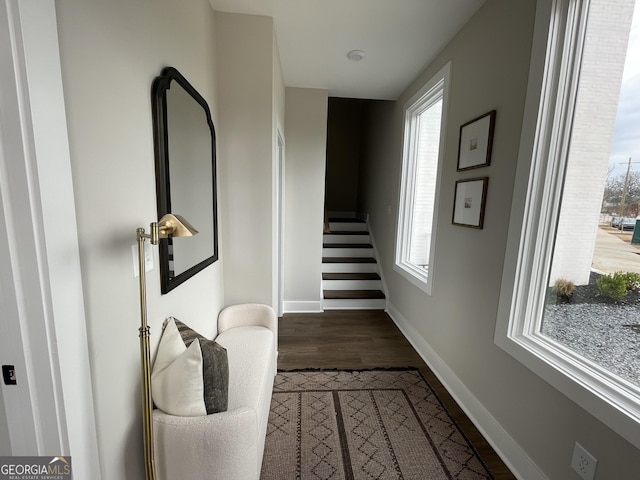 hall with stairway, baseboards, and wood finished floors