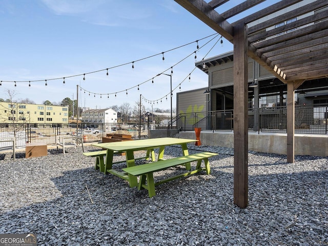 view of property's community featuring fence and a pergola