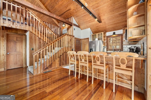 kitchen featuring lofted ceiling, wooden ceiling, hardwood / wood-style floors, stainless steel appliances, and open shelves