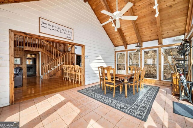 unfurnished dining area featuring wood ceiling, beam ceiling, stairway, and tile patterned flooring