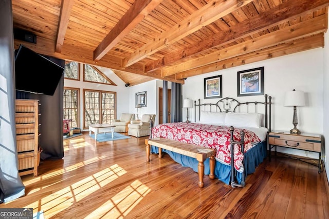 bedroom featuring lofted ceiling with beams, wood-type flooring, and wood ceiling