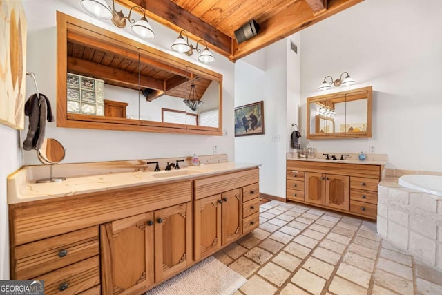 bathroom featuring two vanities, beamed ceiling, wooden ceiling, and a sink