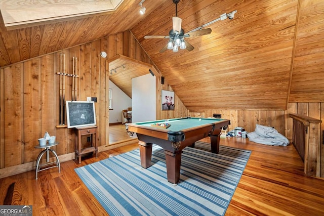 rec room with lofted ceiling, wood walls, wooden ceiling, and wood finished floors