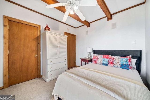 carpeted bedroom featuring beamed ceiling and ceiling fan