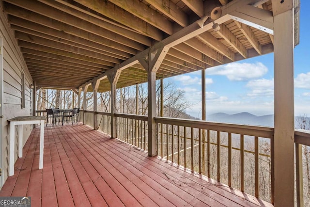 wooden terrace with outdoor dining area