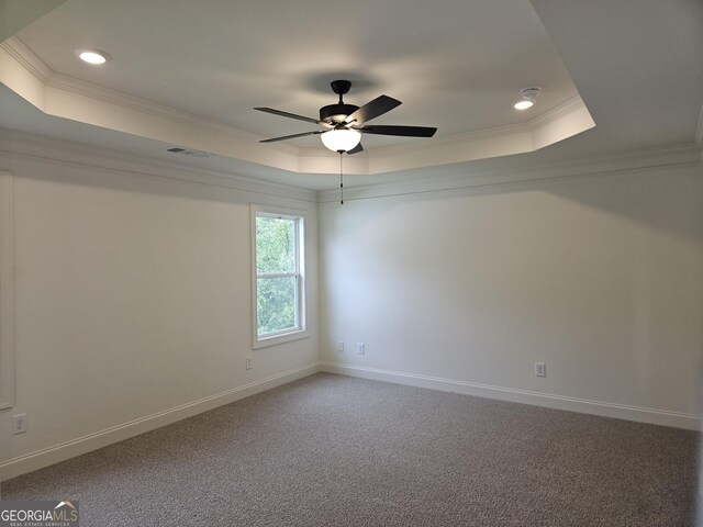 carpeted empty room featuring a raised ceiling, ceiling fan, crown molding, and recessed lighting