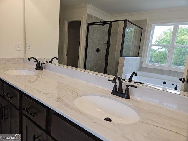 full bathroom featuring a stall shower, double vanity, and a sink