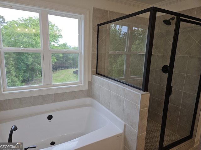 bathroom featuring a garden tub and a shower stall