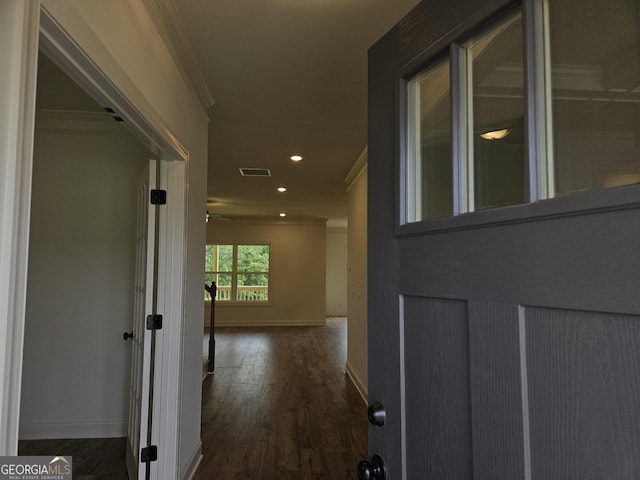 hallway with recessed lighting, visible vents, baseboards, ornamental molding, and wood finished floors
