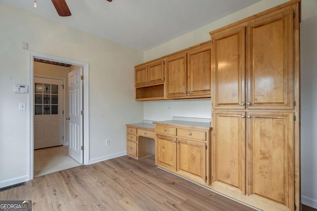 kitchen featuring light wood-type flooring, baseboards, visible vents, and a ceiling fan