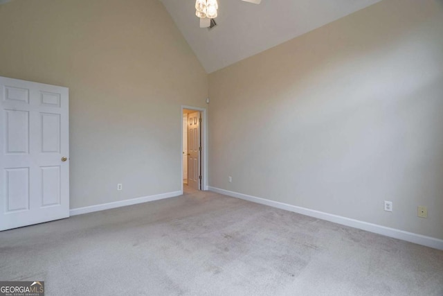 unfurnished bedroom with high vaulted ceiling, carpet, and baseboards