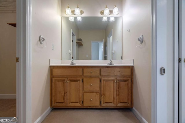 full bathroom featuring double vanity, a sink, and baseboards