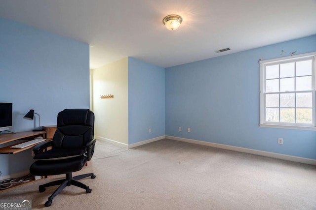 carpeted office with visible vents and baseboards