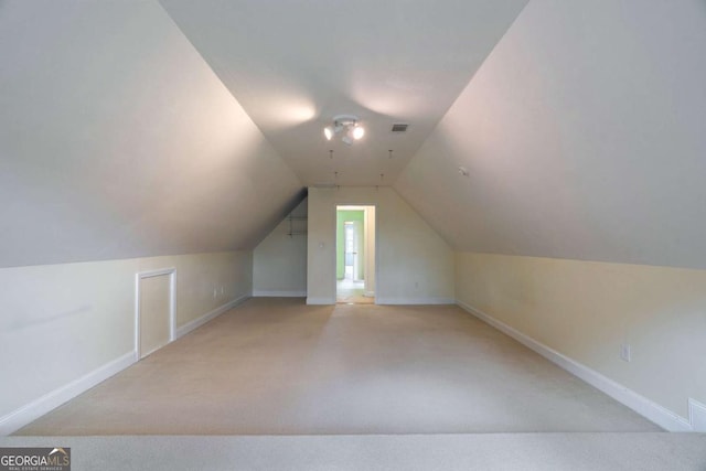 bonus room with vaulted ceiling, carpet flooring, visible vents, and baseboards