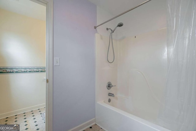 bathroom featuring shower / bath combo, baseboards, and tile patterned floors