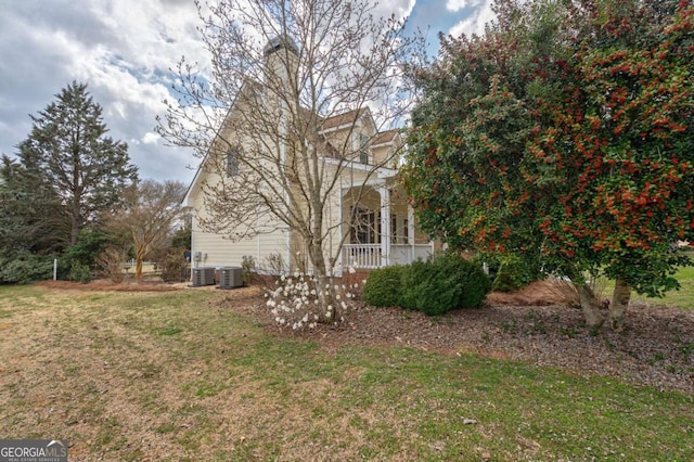 view of home's exterior featuring a yard and central AC unit