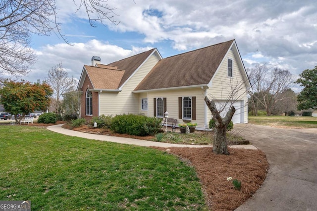 view of home's exterior featuring an attached garage, brick siding, driveway, a lawn, and a chimney