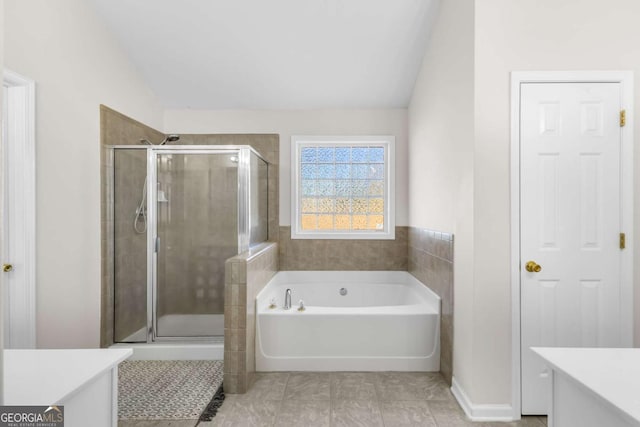 full bathroom with lofted ceiling, a shower stall, a bath, and vanity