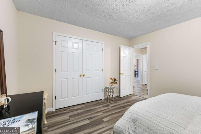 bedroom with wood finished floors, a closet, and a textured ceiling