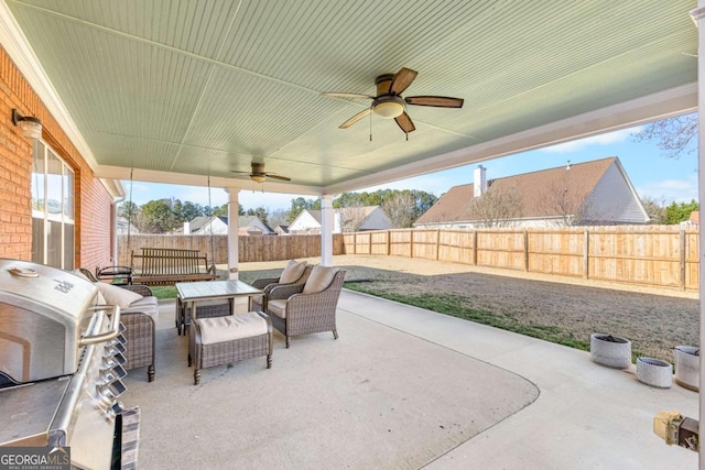 view of patio featuring outdoor lounge area, area for grilling, a fenced backyard, and ceiling fan