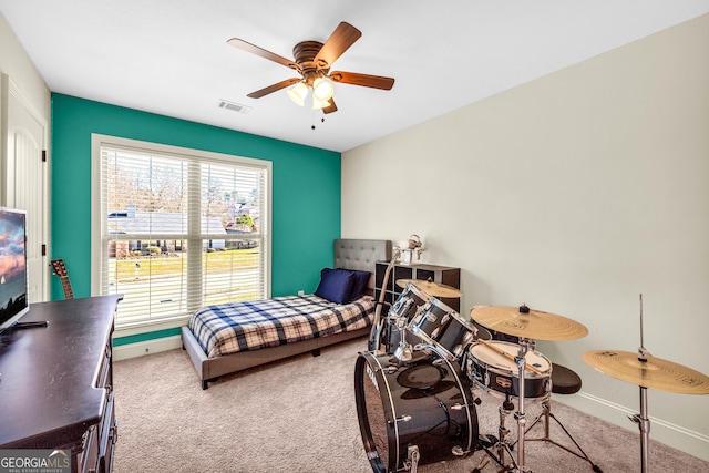 carpeted bedroom with ceiling fan, visible vents, and baseboards