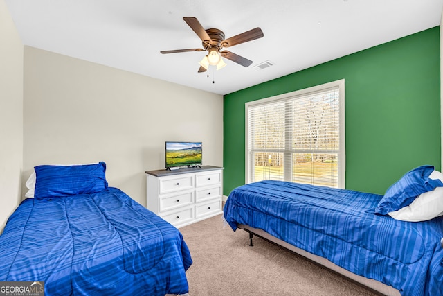 bedroom with ceiling fan, carpet, and visible vents