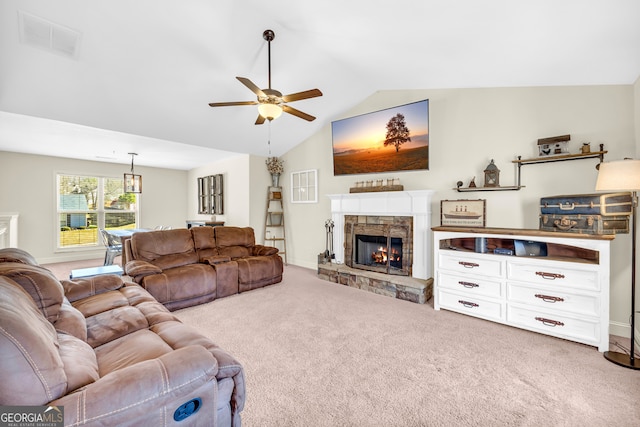 living area featuring visible vents, a ceiling fan, lofted ceiling, carpet floors, and a fireplace