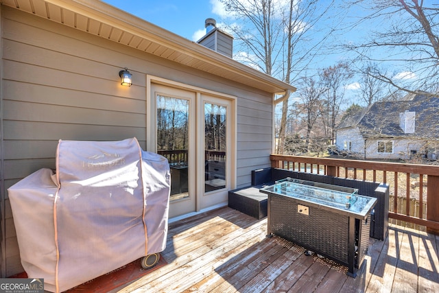 wooden deck featuring grilling area