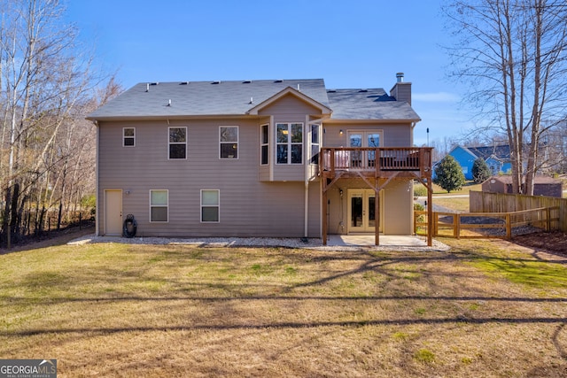 back of property featuring french doors, a patio, a lawn, fence, and a deck