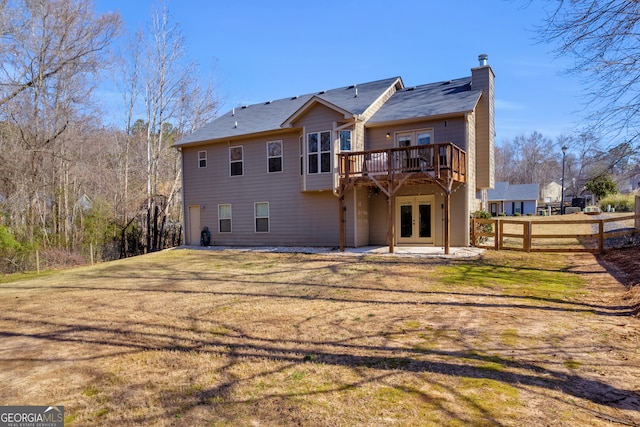 rear view of property with a yard, french doors, a patio area, and fence