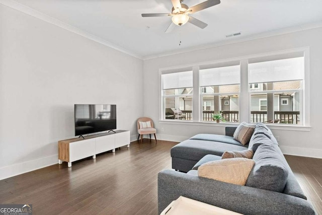 living room featuring baseboards, visible vents, a ceiling fan, dark wood-style floors, and ornamental molding