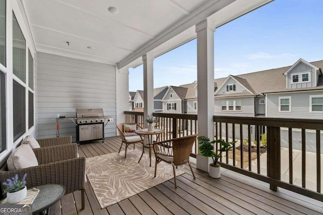 deck featuring grilling area and a residential view