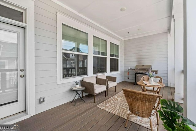 deck with a porch and a grill