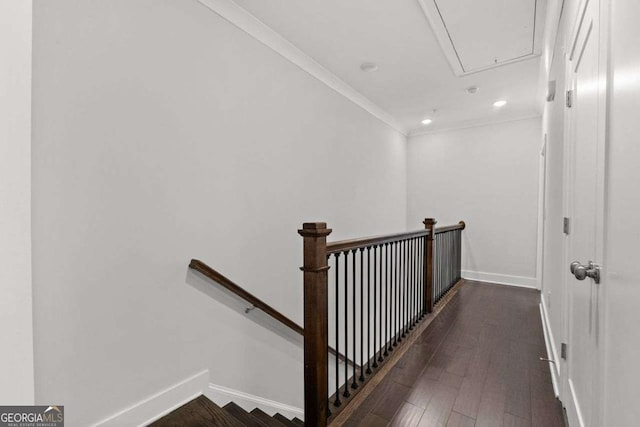 stairs with crown molding, recessed lighting, attic access, wood finished floors, and baseboards